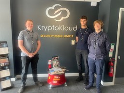 Three KryptoKloud cyber apprentices in front of the KryptoKloud logo